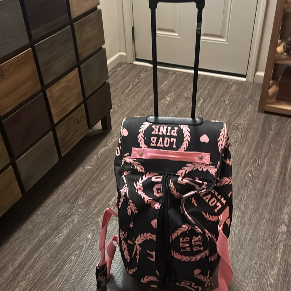 Love pink suitcase on wheels